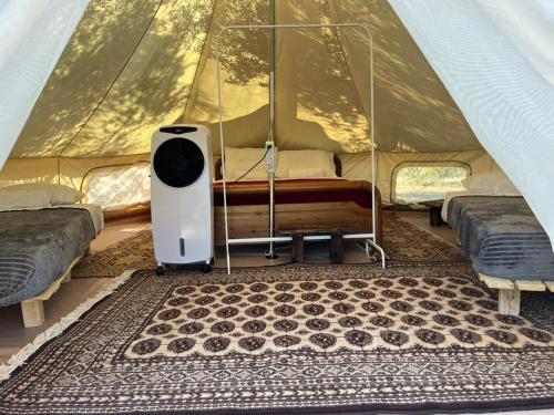 a tent with two beds and a rug in a room at Eco Glamping with Pool between Nafplio and Argos in Argos