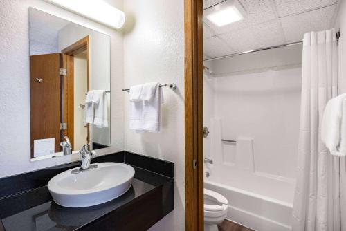 a white bathroom with a sink and a toilet at Baymont by Wyndham Gillette in Gillette
