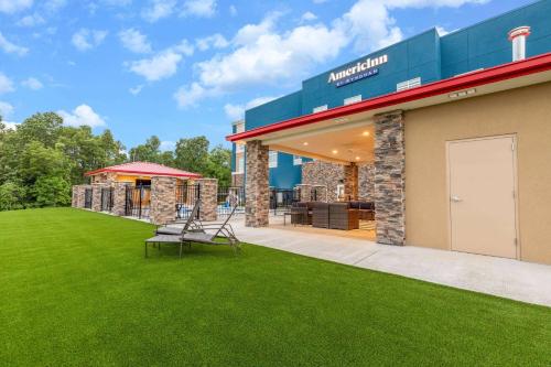 a building with a lawn in front of it at AmericInn by Wyndham Mountain Home in Mountain Home