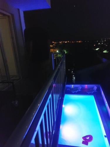 a swimming pool on a balcony at night at Villa Hills in Mostar