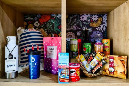 a shelf with a bunch of food and drinks at Hôtel Du Centre, un hôtel AMMI in Nice