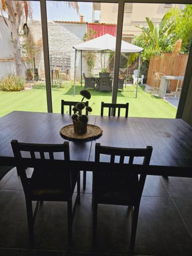 a dining room table with chairs and a plant on it at Trudy's home in Nicosia