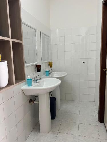 a bathroom with two sinks and a mirror at Casaurora Centro Storico in Catania