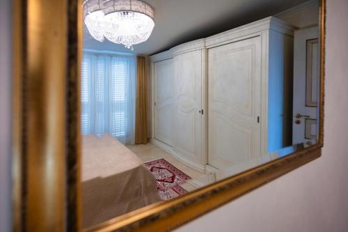 a mirror reflection of a room with a chandelier at Atticus Apartment in Giardini Naxos