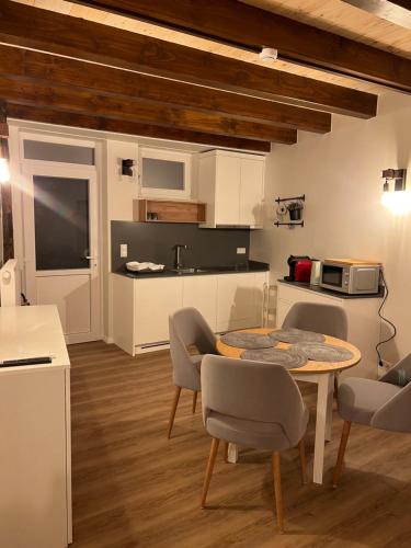 a kitchen and dining room with a table and chairs at Hotel Le Postillon in Echternach