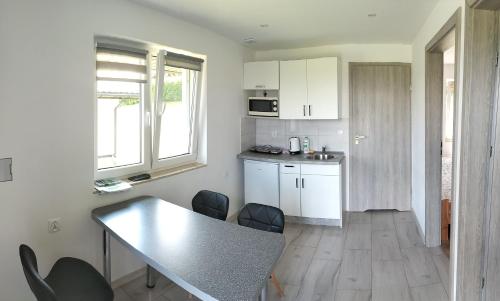 a kitchen with a table and chairs in a room at Bieszczadzki Orzeł in Berezka