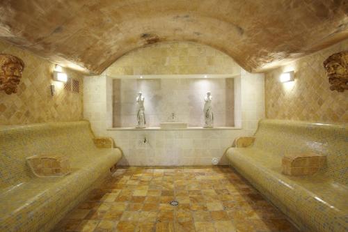 a bathroom with two beds and two statues on the wall at Grupotel Parc Natural & Spa in Playa de Muro