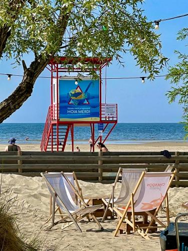 two chairs and a screen on the beach at Villa Blue Heaven Pärnu in Pärnu