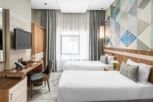 Postel nebo postele na pokoji v ubytování Roots Hotel