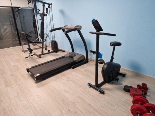 a gym with two exercise bikes on a wooden floor at Malasaña Dreams S,L in Madrid