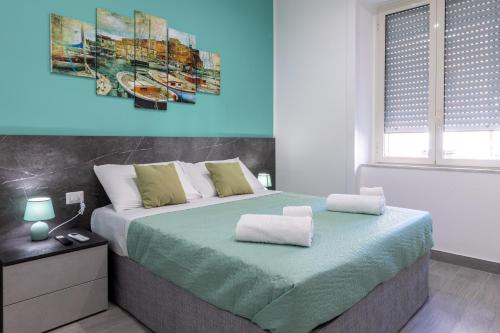 a bedroom with a large bed with two pillows on it at Partenope Guest House in Naples