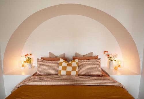 a bedroom with a bed with an arch above it at Luxury hideaway holiday unit in CBD in Mount Gambier