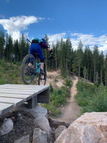 a person on a bike jumping over a wooden bridge at In the middle of Trysilfjellet - Welcome Center - Apartment with 3 bedrooms - By bike arena and ski lift in Trysil