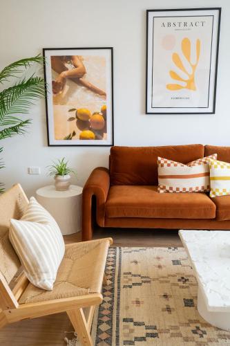 a living room with a brown couch and a rug at Luxury hideaway holiday unit in CBD in Mount Gambier