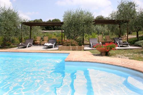 a swimming pool in a yard with a gazebo at Tenuta Sant'Ilario in Gambassi Terme