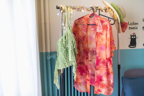 a dress hanging on a rack in a room at Sweet home in Koukaki in Athens