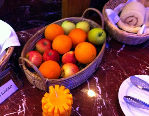 two baskets of fruit on a table with a pumpkin at Century Park Residence in Dhaka