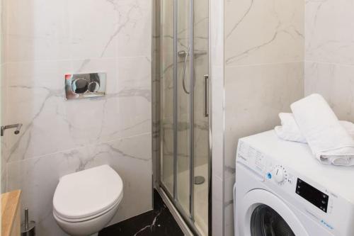 a bathroom with a toilet and a washing machine at #43 Design Studio Terrace AC Wifi Sea View 1min Beach in Nice