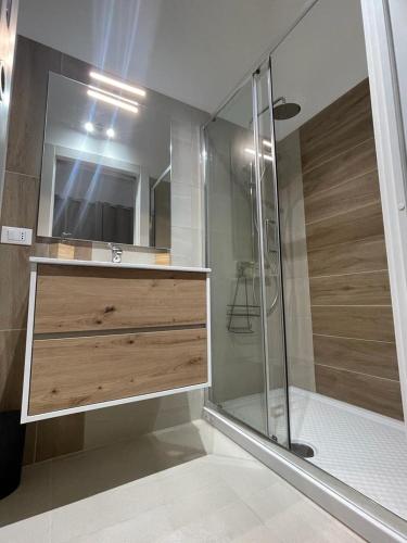 a bathroom with a shower with a sink and a mirror at Terra De Mare in Palmariggi