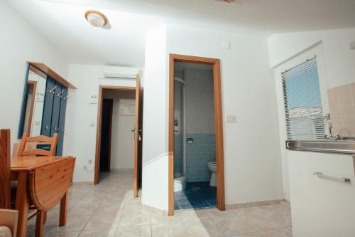 a bathroom with a sink and a toilet at Apartmani Miljak Omiš in Omiš