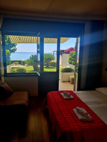 a bedroom with a bed and a large window at Beach Villa Bozikovic in Podstrana