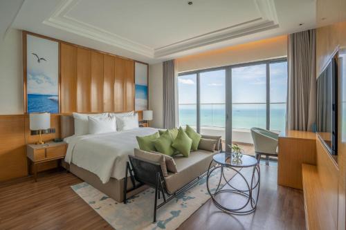 a hotel room with a bed and a television at Grand Hyams Hotel - Quy Nhon Beach in Quy Nhon
