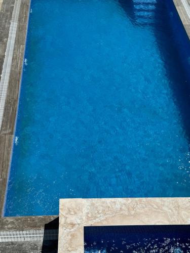 una piscina de agua azul en Villa Novxani, en Baku