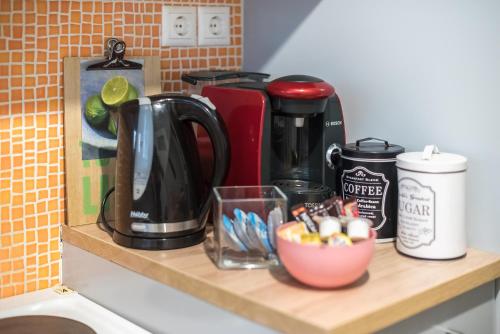 a counter with a coffee maker and a cup on it at Sweet home in Koukaki in Athens