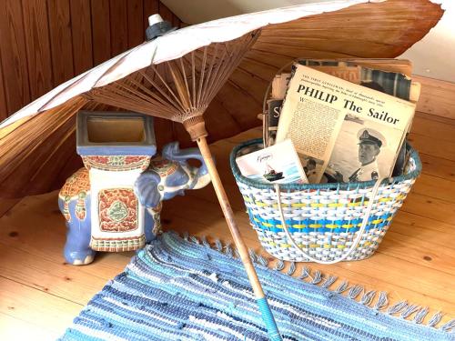 an umbrella and other items on a wooden floor at Villa Blue Heaven Pärnu in Pärnu