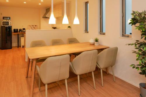 a dining room with a wooden table and chairs at ACOE HATSUDAI - 4BR Entire Home Upscale Area in Tokyo