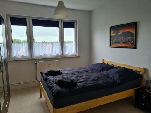 una camera con un letto in una stanza con finestre di Gästewohnung KL. WZL 29_5 