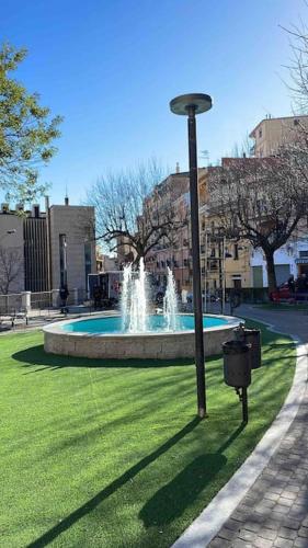 a fountain in a park with a light pole at Casa Funtana e Susu in Jerzu