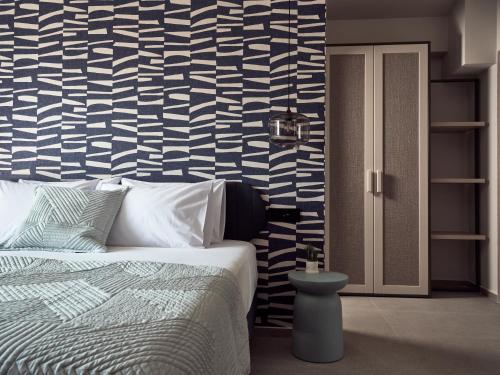 a bedroom with a bed and a blue and white wall at Bardo Villa, Endless Blue with Heated Pool, By ThinkVilla in Argasi
