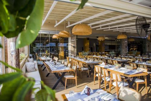 a dining room with wooden tables and chairs at Kasta Beach Hotel in Ofrínion