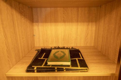 a book sitting on a shelf in a cabinet at Sparrow Apartments Hotel in Jeddah