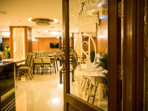 a store window of a store with tables and chairs at Sparrow Apartments Hotel in Jeddah