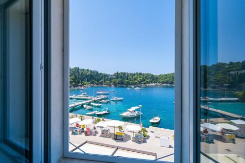 a window view of a marina with boats in the water at Apartments Villa Royale in Cavtat