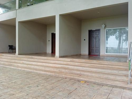an empty room with a wooden floor and a door at UVA Sands Beach Resort in Kundapur