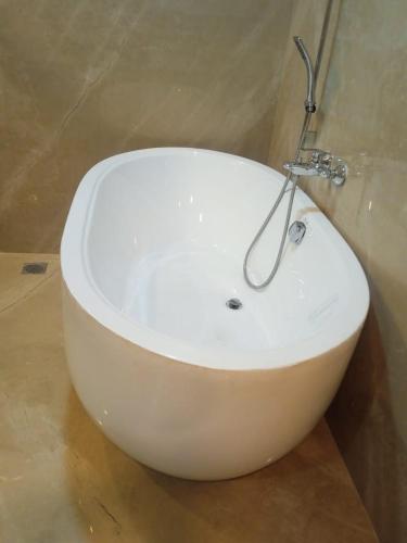 a white sink with a faucet in a bathroom at UVA Sands Beach Resort in Kundapur