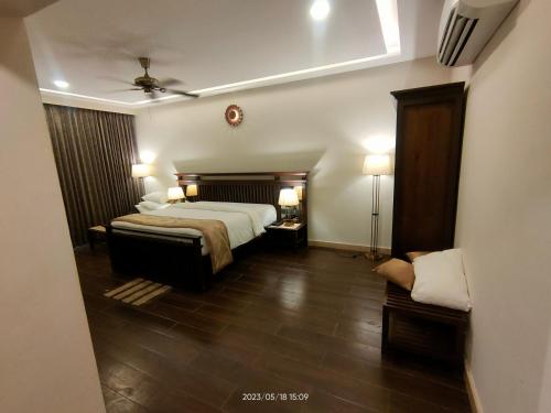 a hotel room with a bed and two lamps at UVA Sands Beach Resort in Kundapur