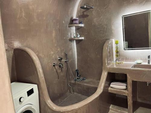 a bathroom with a shower and a sink at Cave of Love Seafront Sunset View Santorini in Akrotiri