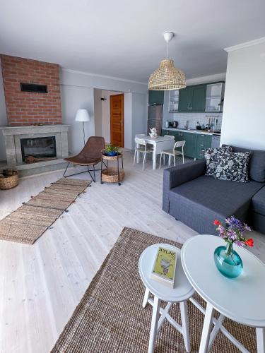 a living room with a couch and a fireplace at Assos Sizin Ev in Ayvacık