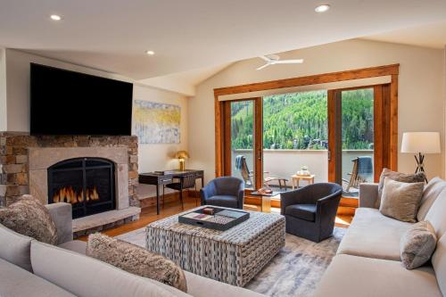 a living room with a fireplace and a tv at The Hythe, a Luxury Collection Resort, Vail in Vail