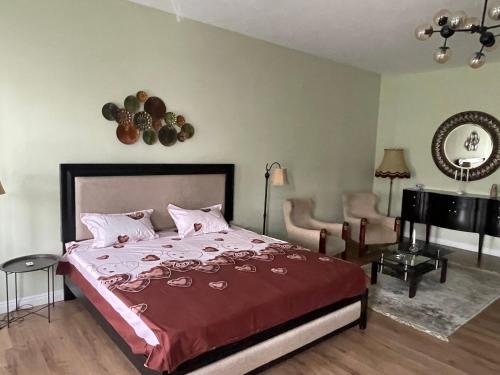a bedroom with a bed with a red comforter at CozyFlat in the central Arad in Arad