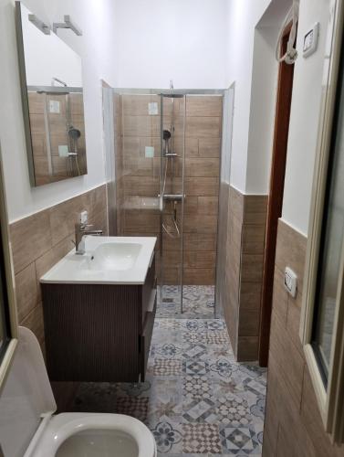 a bathroom with a shower and a sink and a toilet at casaafauka in Carini