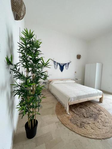 a bedroom with a bed and a potted plant at Terra De Mare in Palmariggi