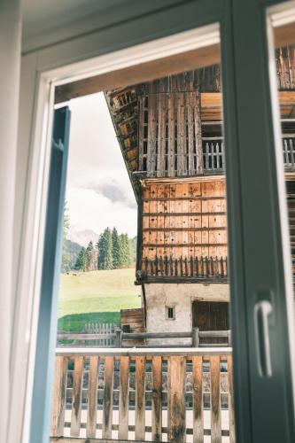 a view of a building from a window at Kristiania Small Dolomites Hotel in Selva di Val Gardena