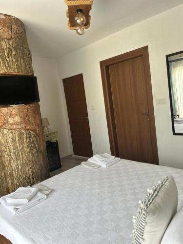 a bedroom with a bed with two towels on it at Pupa Alaçatı Butik Otel in Cesme