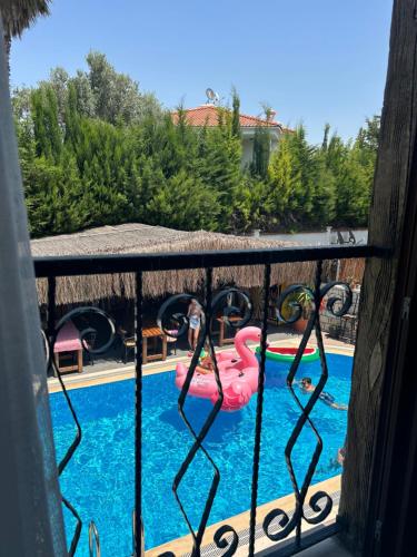 a view of a pool with a pink water slide at Pupa Alaçatı Butik Otel in Cesme