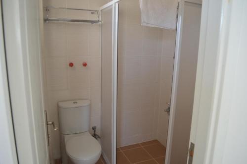 a small bathroom with a toilet and a shower at Yasmin Hotel in Ayvalık